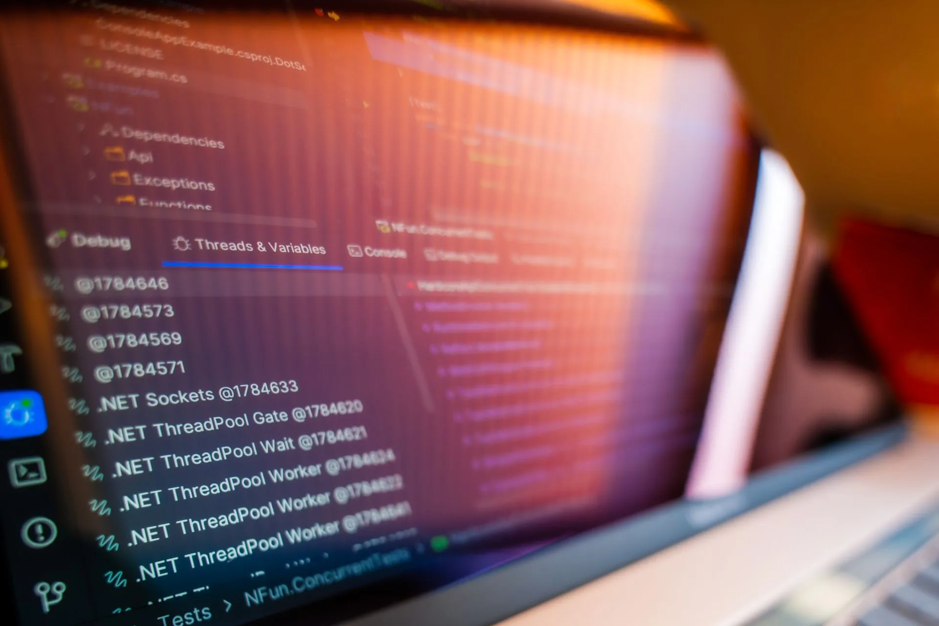 Focused view of a computer screen displaying code and debug information, illustrating OpenAI's Codex Security Cloud hunts code flaws and drafts fixes while laptops are shut