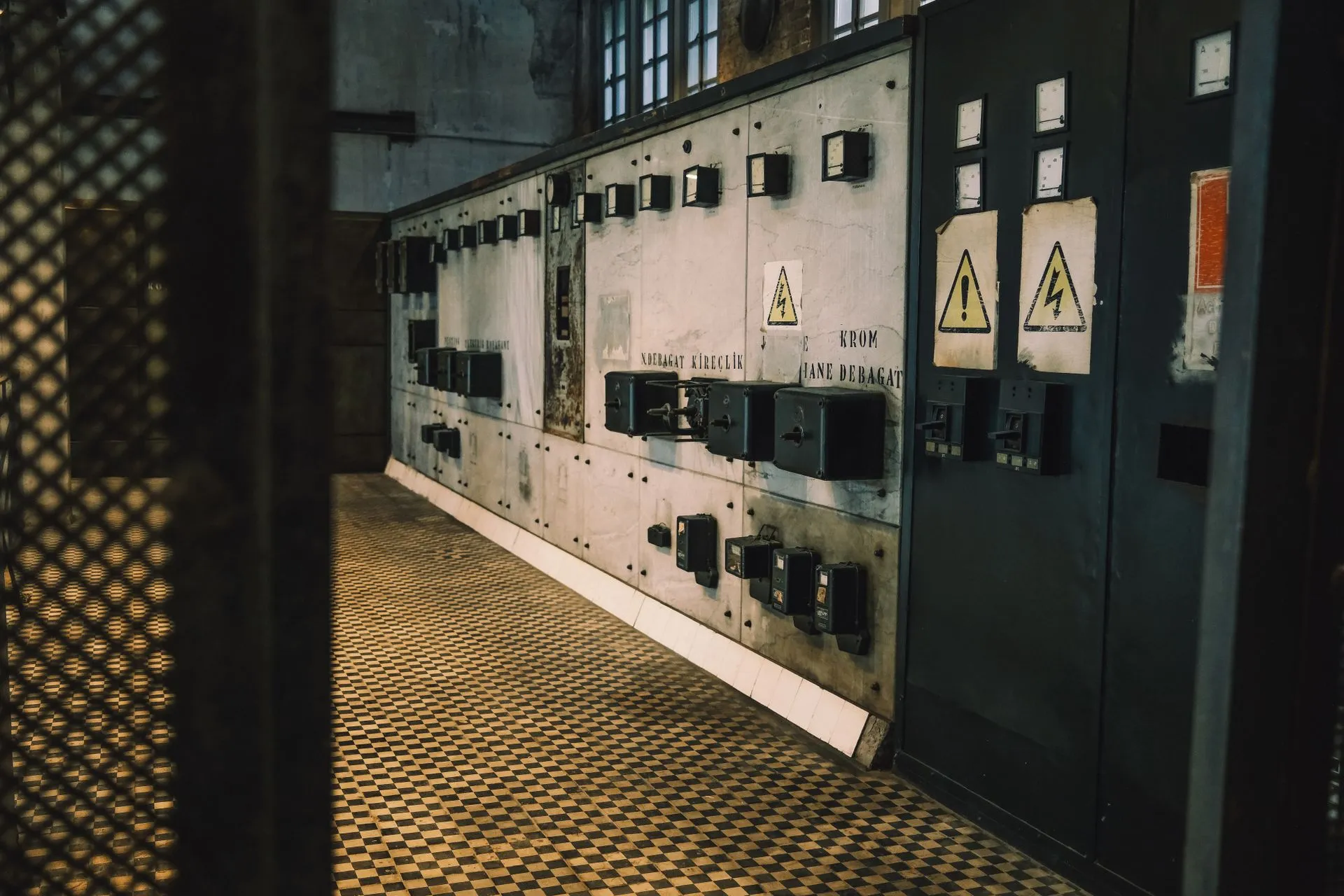 Vintage industrial control panel with warning signs in a dimly lit room, creating a moody atmosphere, illustrating OpenAI DevDay