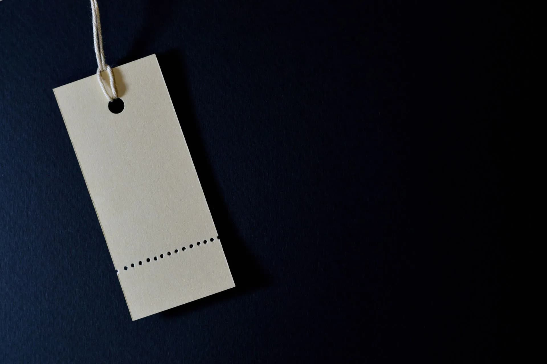Elegant minimalist card with a string, ideal for labeling or pricing against a black background, illustrating OpenAI's GPT-6.1 Sol undercuts its own flagship at one-fifth of Astra's