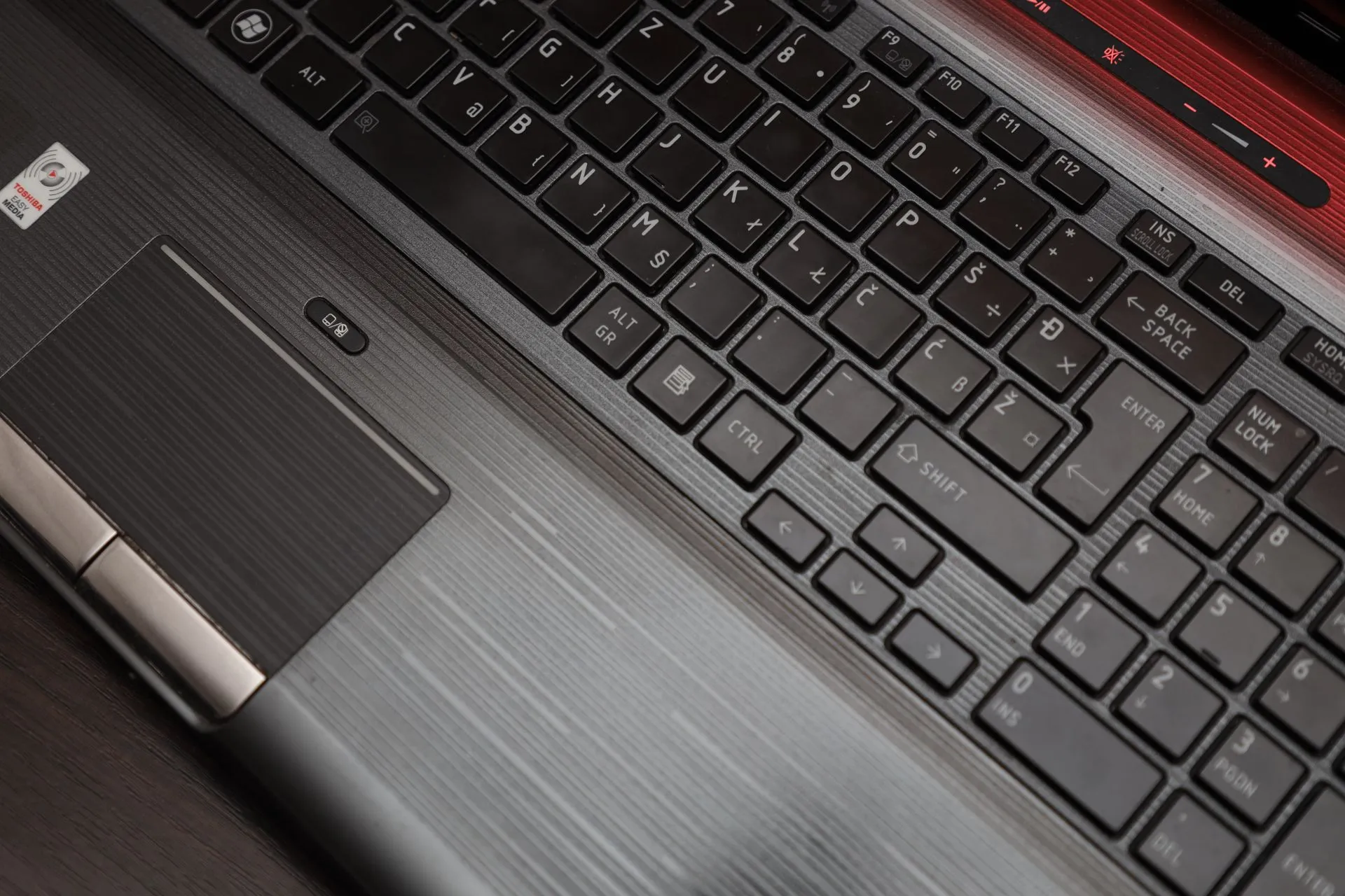Detailed top view of a laptop keyboard and touchpad, ideal for technology themes, illustrating OpenAI lawsuit claims its AI agents broke California hacking law in Hugging Face breach