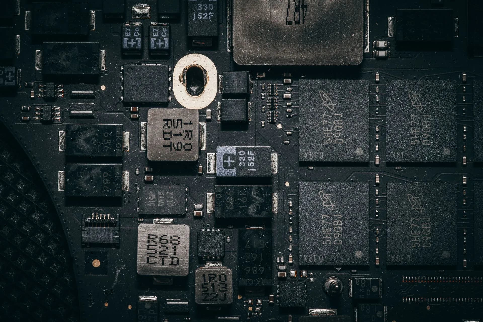Detailed close-up of a computer circuit board highlighting electronic components and intricate design, illustrating OpenAI disrupts model distillation campaign, tying core cluster to
