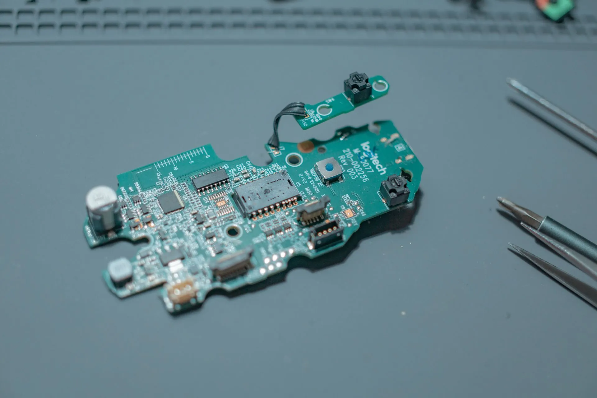 Detailed view of a circuit board with electronic components and tools, illustrating OpenSSL and wolfSSL patch high-severity flaws, including a DTLS bug that can leak heap memory