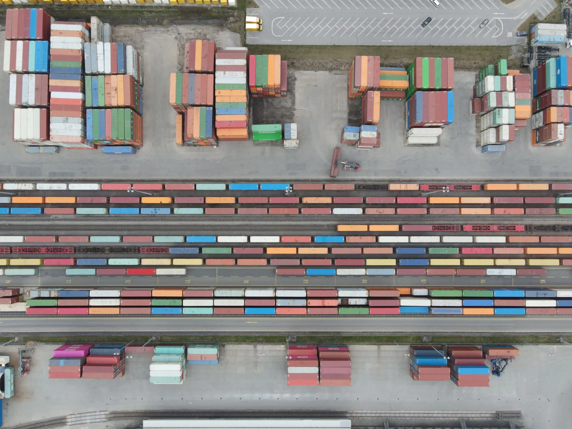 Aerial shot of stacked cargo containers at Regensburg port showcasing freight transport activity, illustrating Parallel Systems raises $100M Series C to scale autonomous electric