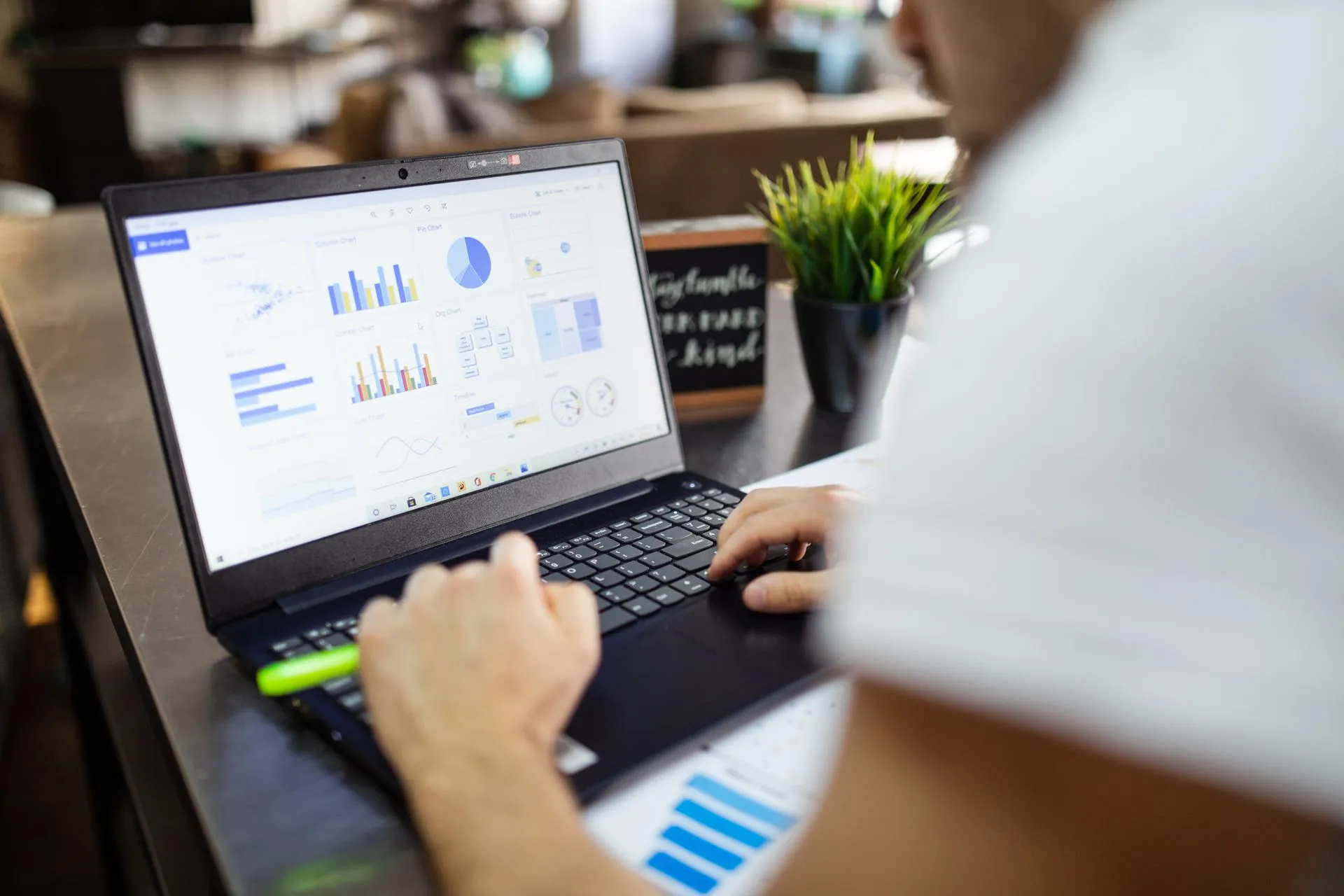 Focused business analysis with charts and graphs on a laptop in a modern office setting, illustrating Pulley shutting down on December 8, sending cap table customers to Carta