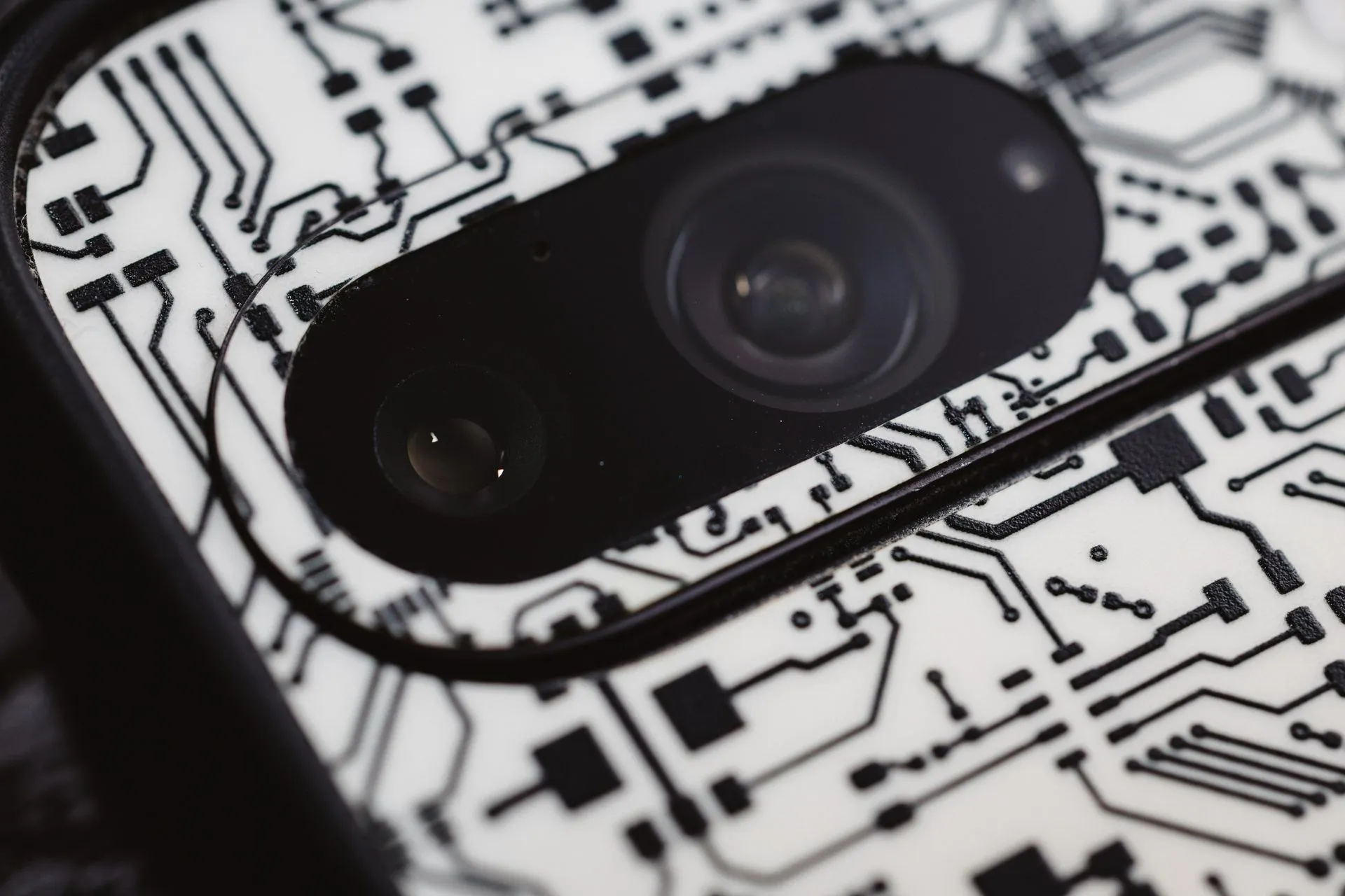 Macro shot of an electronic circuit design around a smartphone camera lens, showing intricate details, illustrating Pwn2Own Ireland pays $1,262,000 for 98 zero-days as Pixel 10 and
