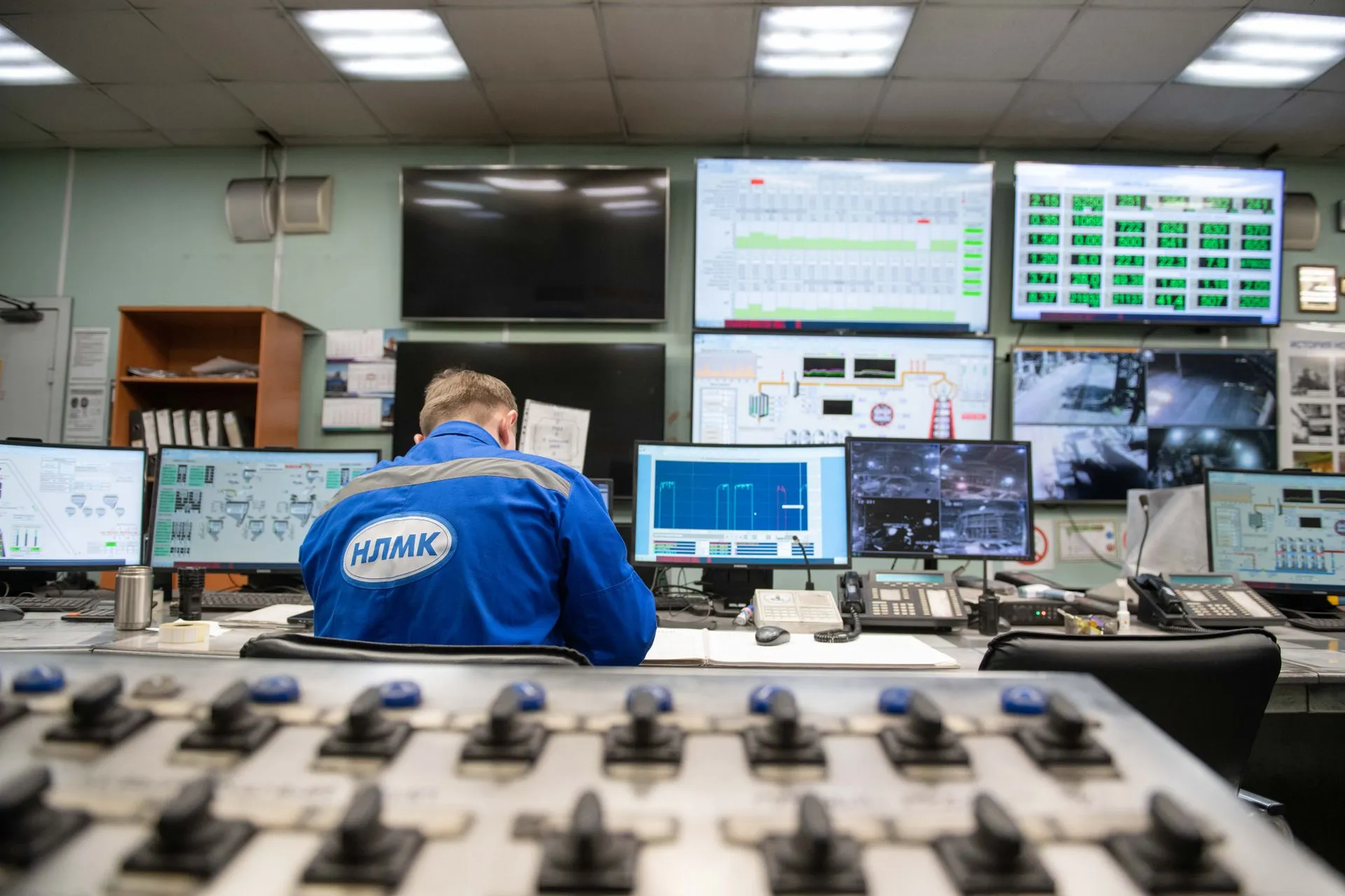 An engineer monitors multiple screens in an industrial control room, ensuring smooth operations, illustrating Rapid7 launches Rapid7 Intelligence, feeding its threat research straight
