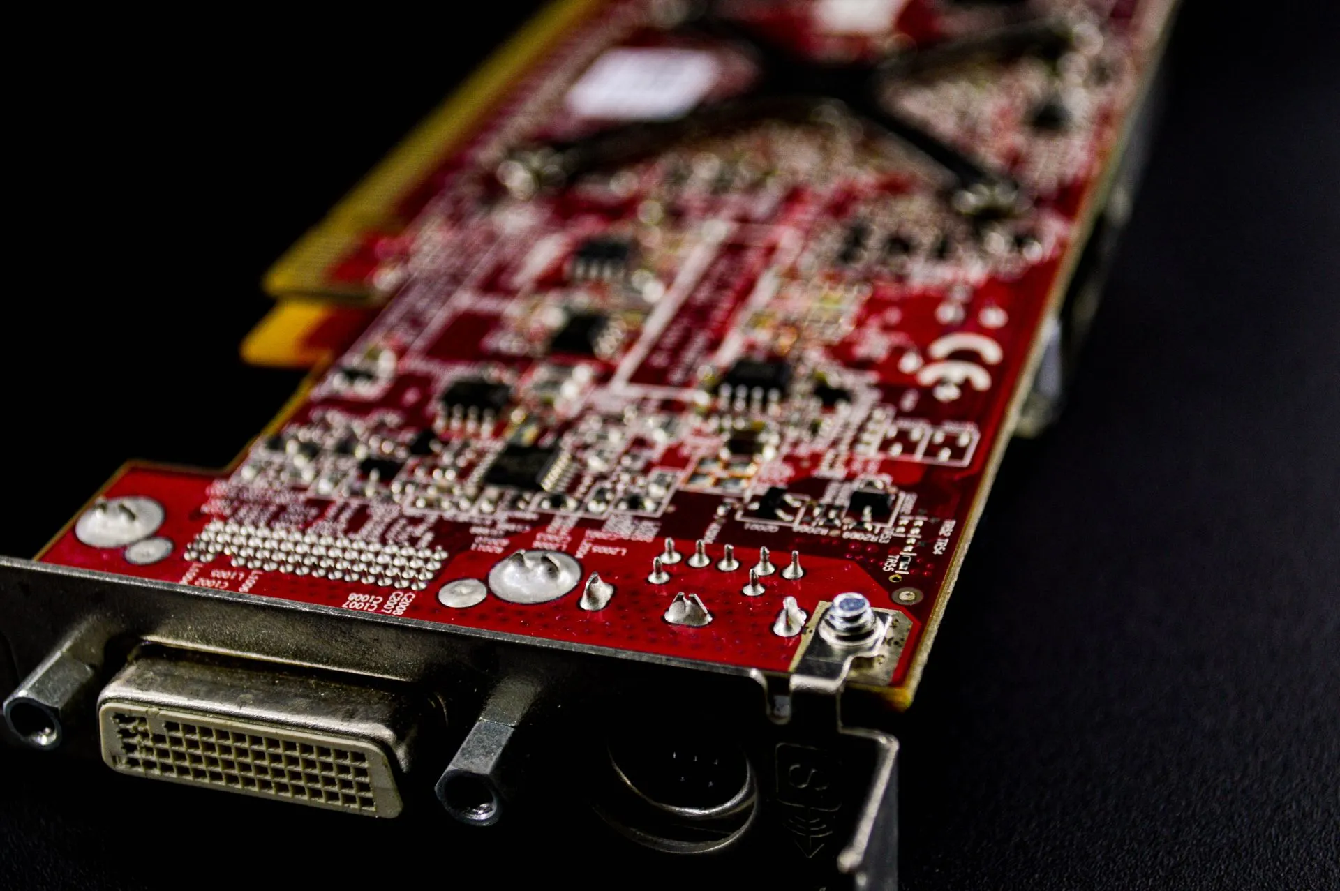 Detailed close-up of a red circuit board showcasing electronic components.
