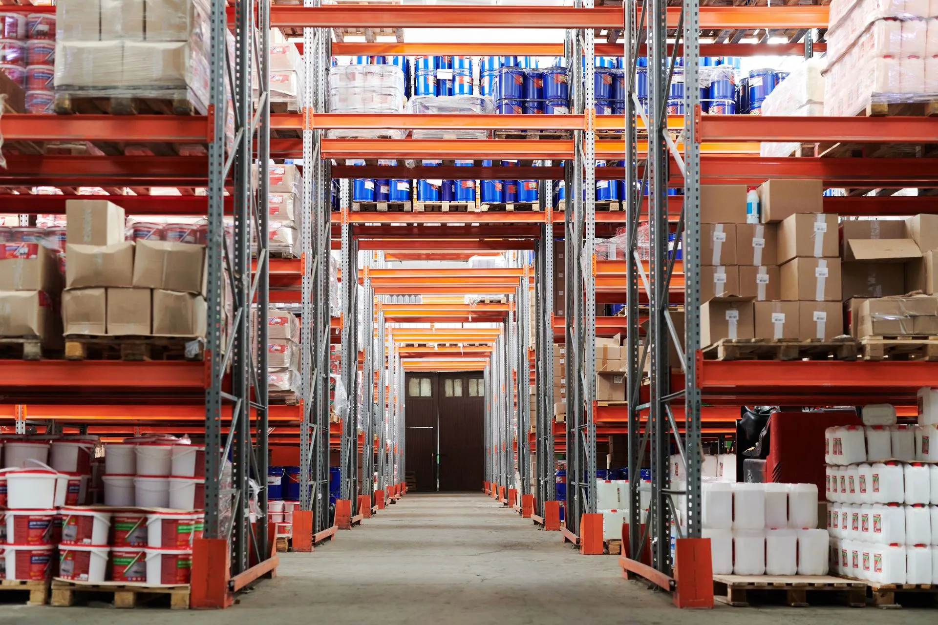 Wide angle view of a warehouse with stocked shelves and boxes, illustrating SAP makes Joule an agentic work layer as its Autonomous Enterprise reaches general availability
