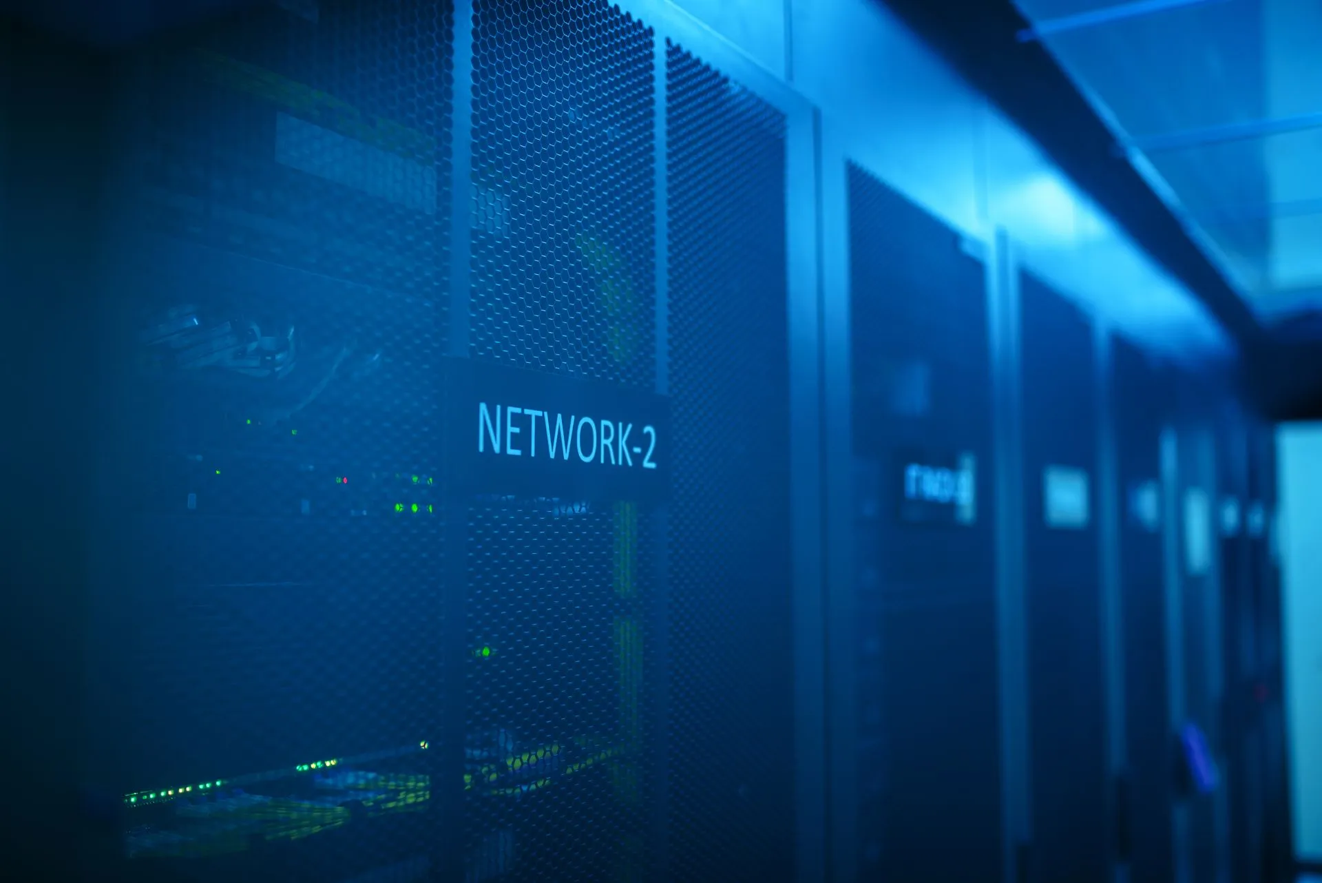 A modern server room featuring network equipment with blue illumination. Ideal for technology themes, illustrating Bitget's nine-figure theft and Citrix zero-days put security vendor