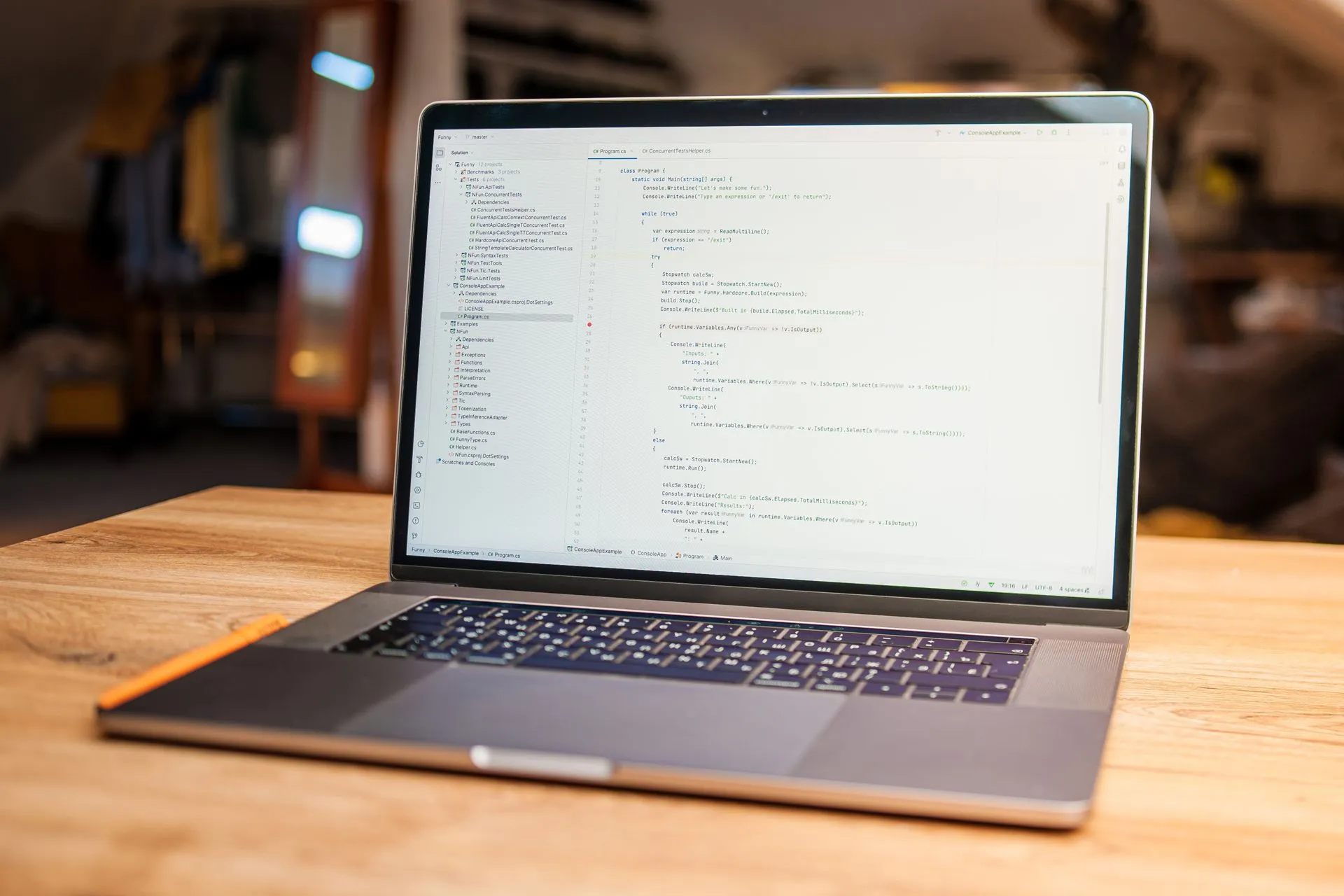 Open laptop with visible code on screen on a wooden desk in a modern, cozy workspace, illustrating Shai-Hulud worm hits Tensorlake npm SDK, stealing cloud and GitHub secrets from AI