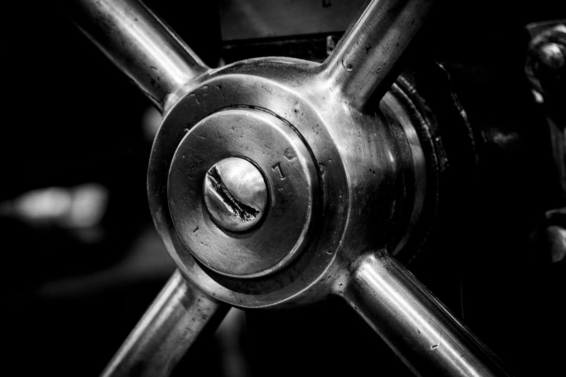 Detailed black and white image of an industrial metal cog showcasing intricate machinery design, illustrating South Korea bank breaches hit Shinhan, KB and Hana amid suspected