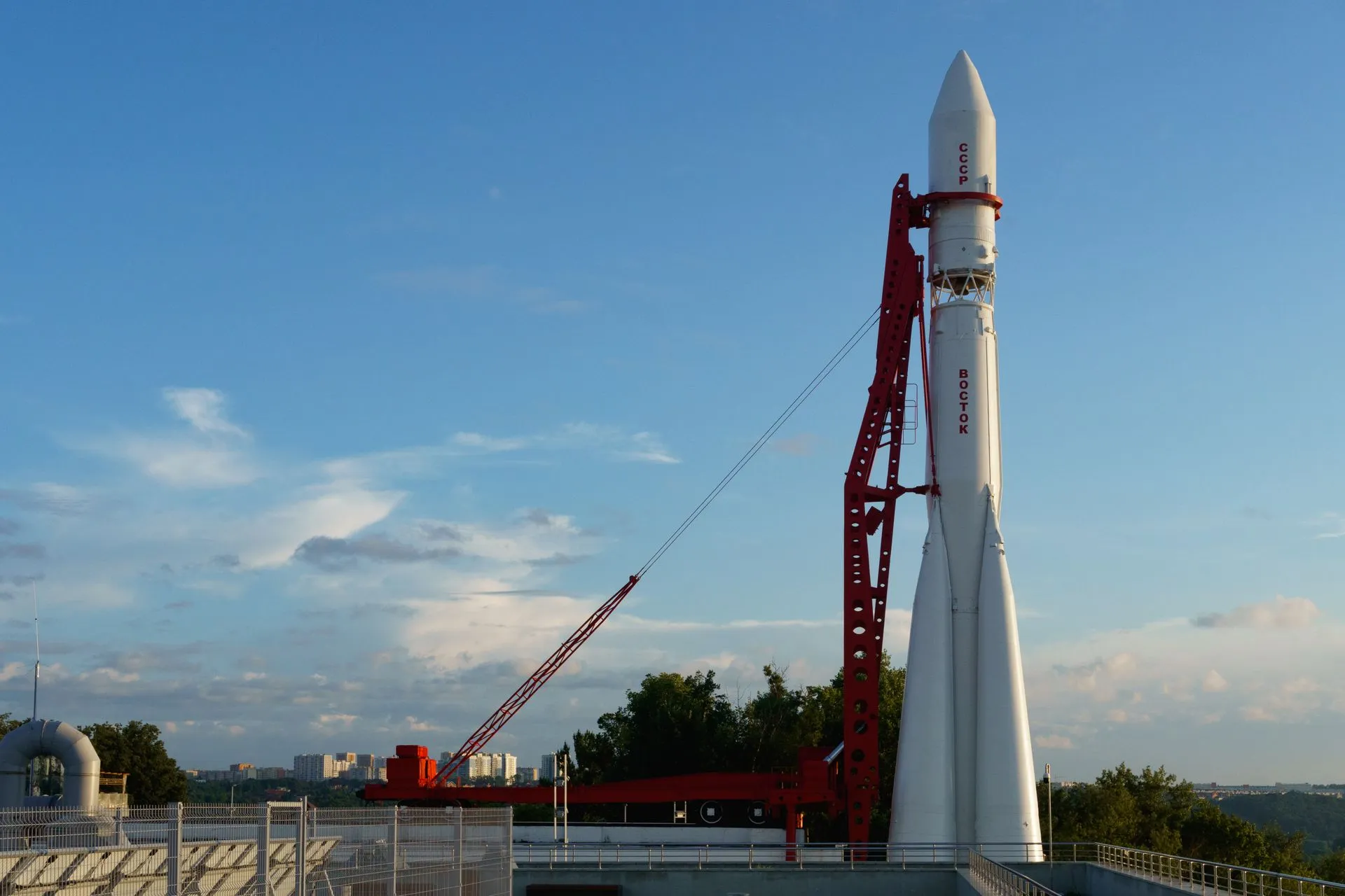 Vostok rocket stands poised on launch pad under clear blue sky at space center, illustrating SpaceX Starship reaches orbit for the first time and releases 26 Starlink satellites
