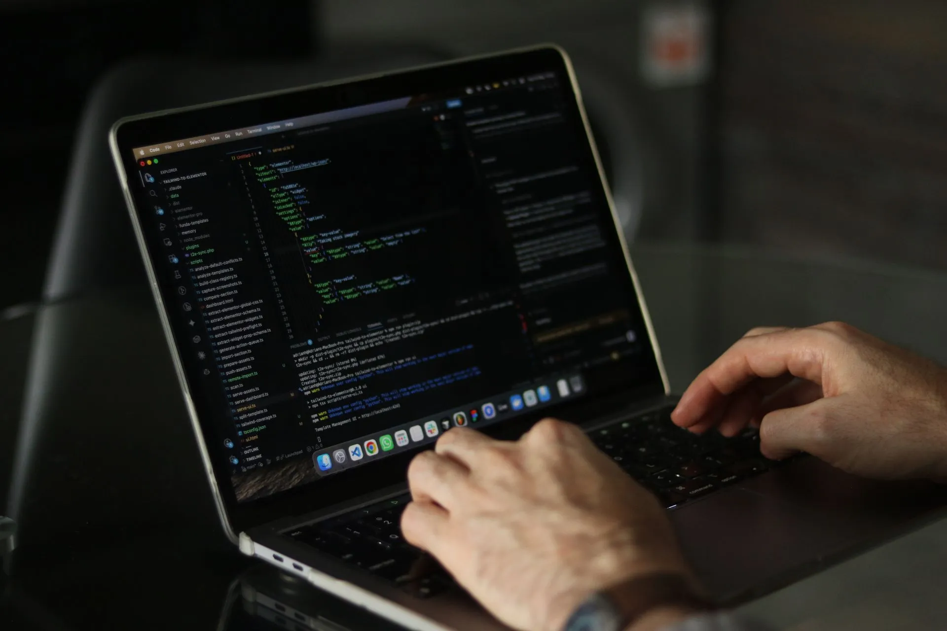Close-up of hands coding on a laptop, focusing on programming productivity, illustrating Spotify enterprise software push puts Backstage, Portal and Confidence under one site
