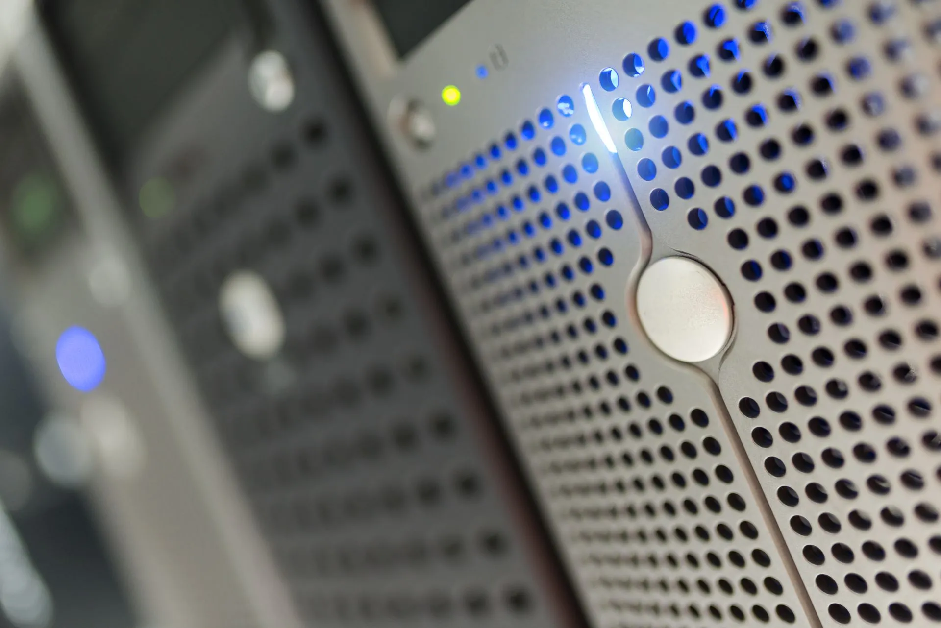 Focused detail of a modern server rack with blue LED indicators in a data center, illustrating Supabase data exposure