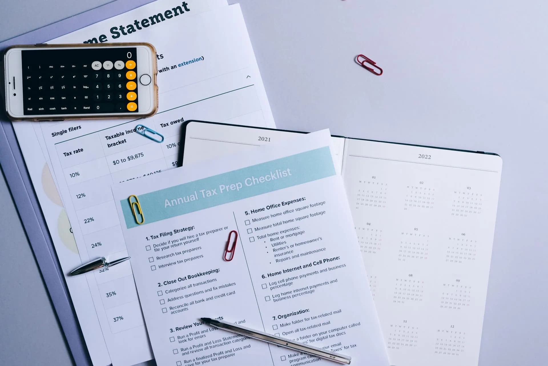 Flat lay of a tax preparation checklist, calculator, and financial documents on a desk, illustrating TrendAI flags 2,457 niche AI tools