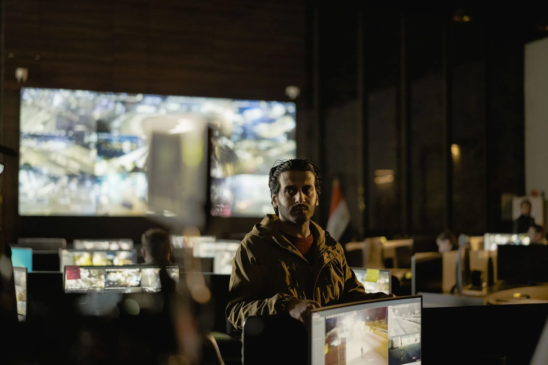 Modern security control room with a diverse team monitoring live surveillance feeds.