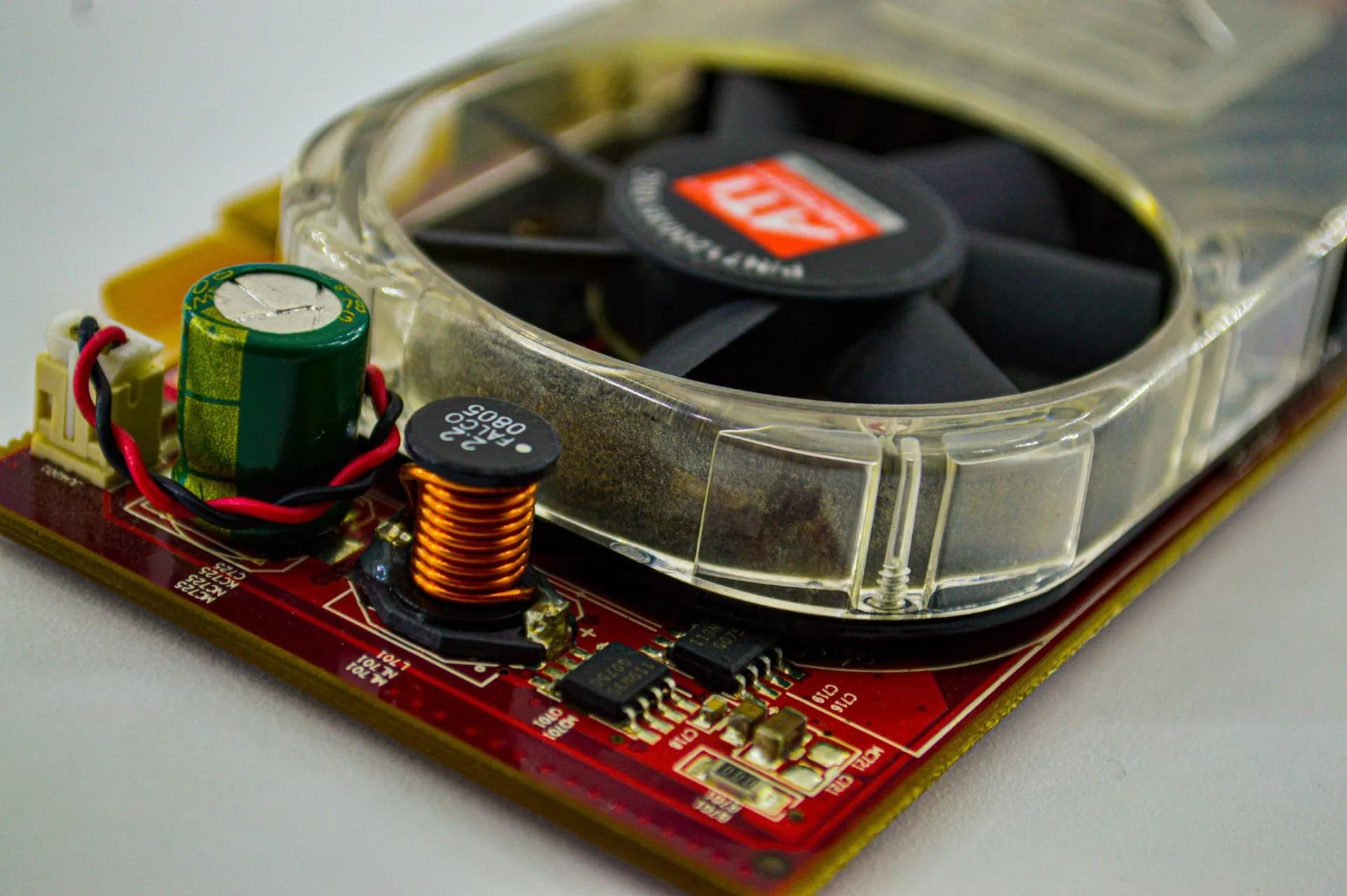 Detailed view of a cooling fan and capacitor on a computer circuit board, showcasing electronic components, illustrating Vinci raises $250 million at a $1.5 billion valuation for AI