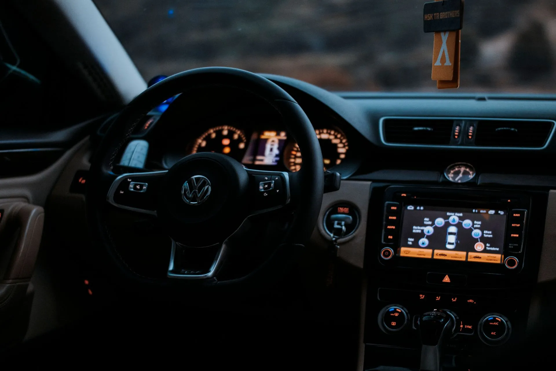Cozy Volkswagen car interior showing dashboard display and steering wheel, illustrating Waymo lines up $5 billion in debt as Uber and Pony.ai take robotaxis to London