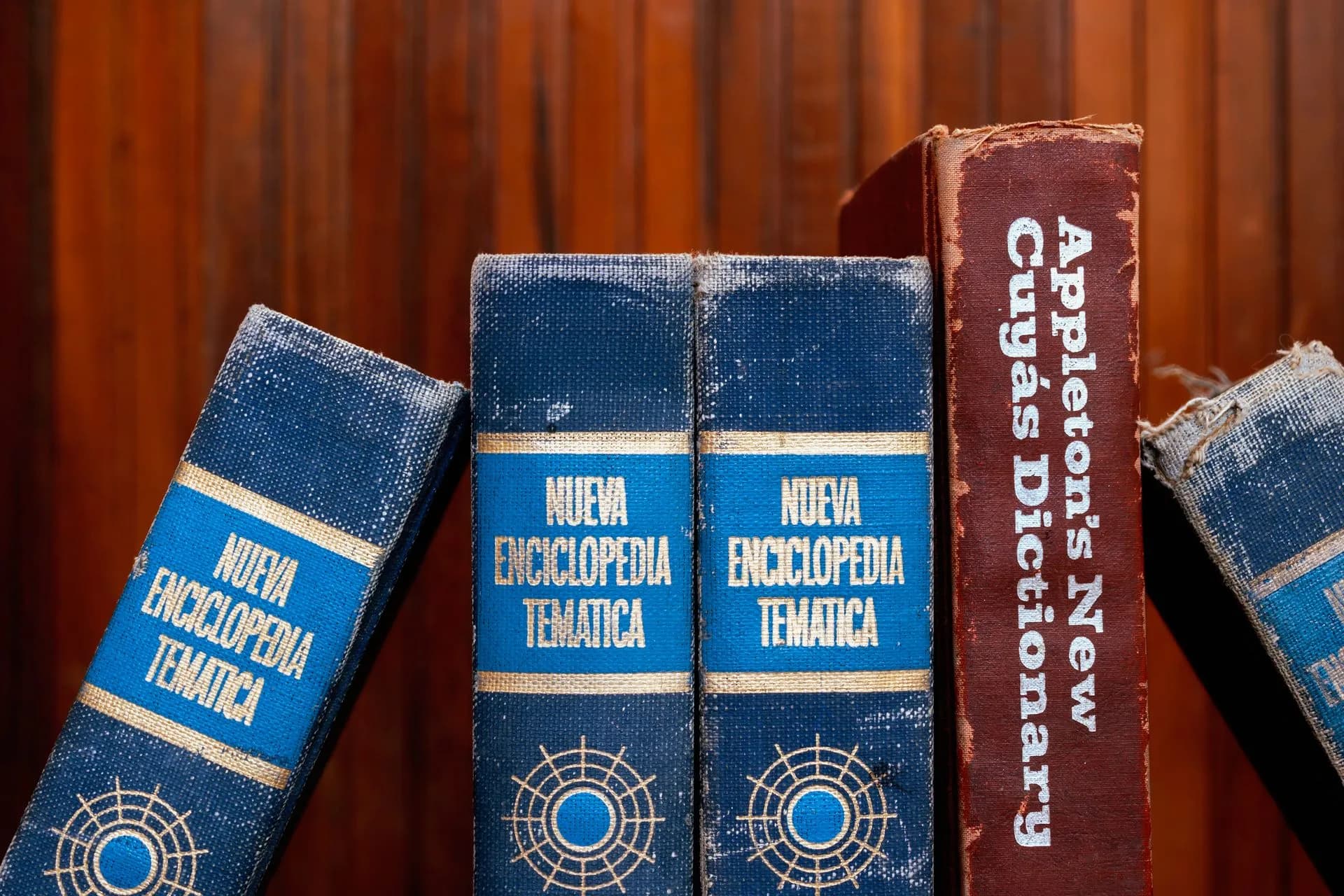 Close-up of old encyclopedias and a dictionary on a wooden shelf, showcasing vintage charm, illustrating Wikimedia says agents it believes OpenAI ran tried to compromise Etherpad, may