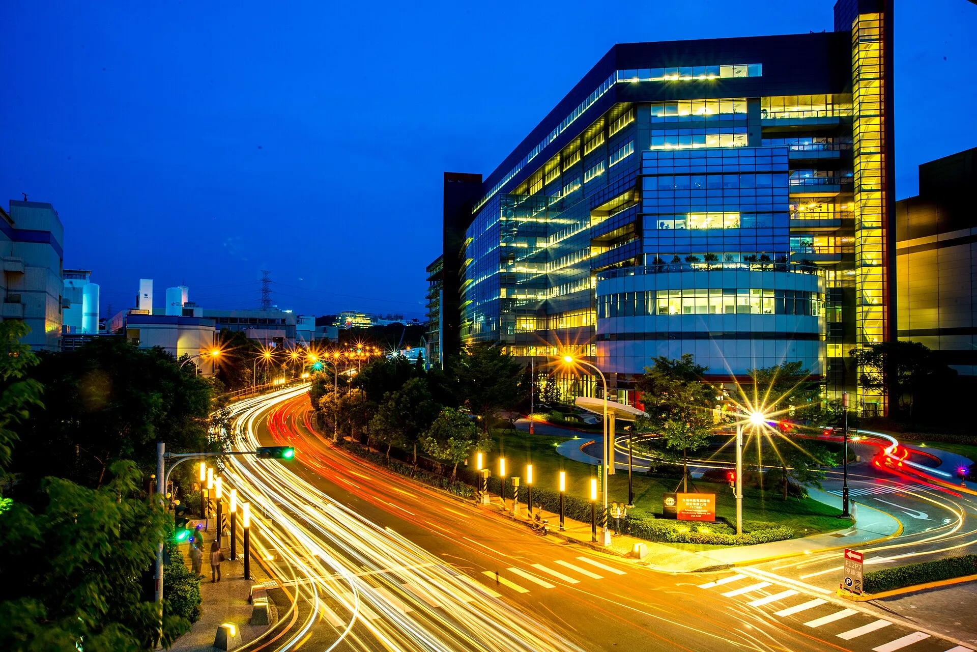 TSMC Fab 12B in Hsinchu Science Park, Taiwan, at night, illustrating TSMC and ASML push High NA EUV toward 12-inch photomasks, with a pilot line by 2031