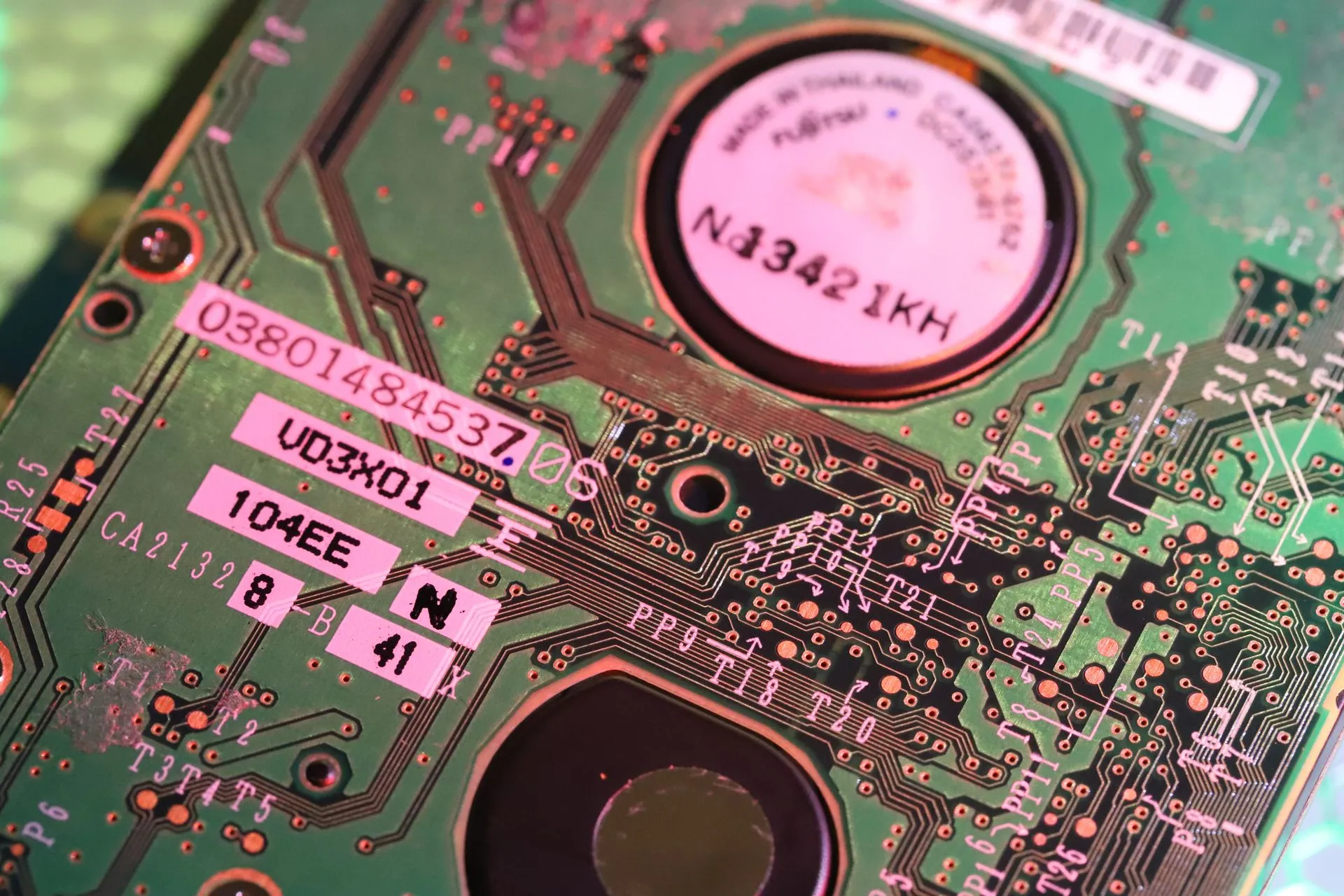 Detailed close-up of a computer circuit board highlighting components and electronic paths, illustrating Kioxia Applied Materials deal