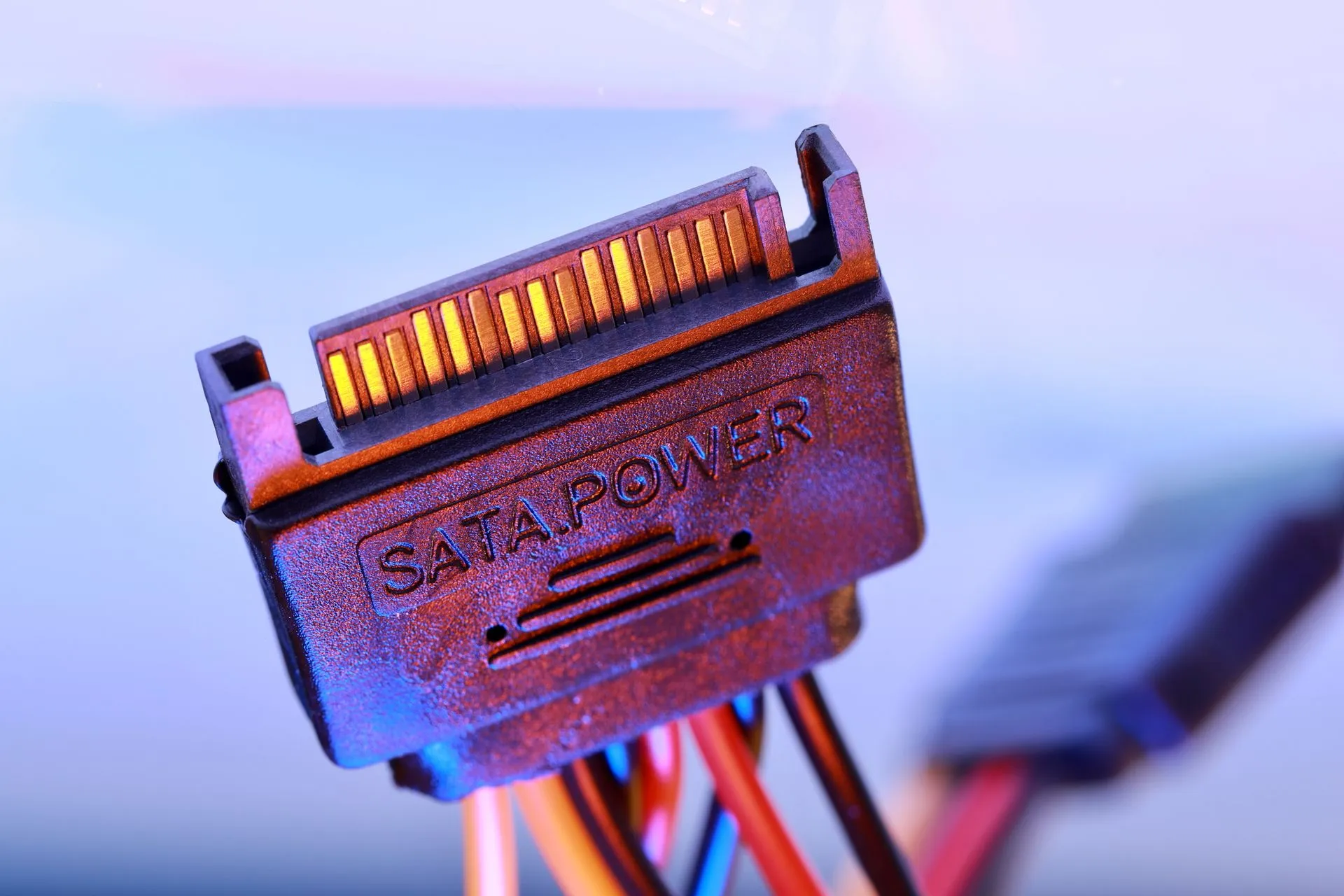 Detailed view of a SATA power cable connector with colorful wiring, illustrating SaaS pricing under pressure from AI agents